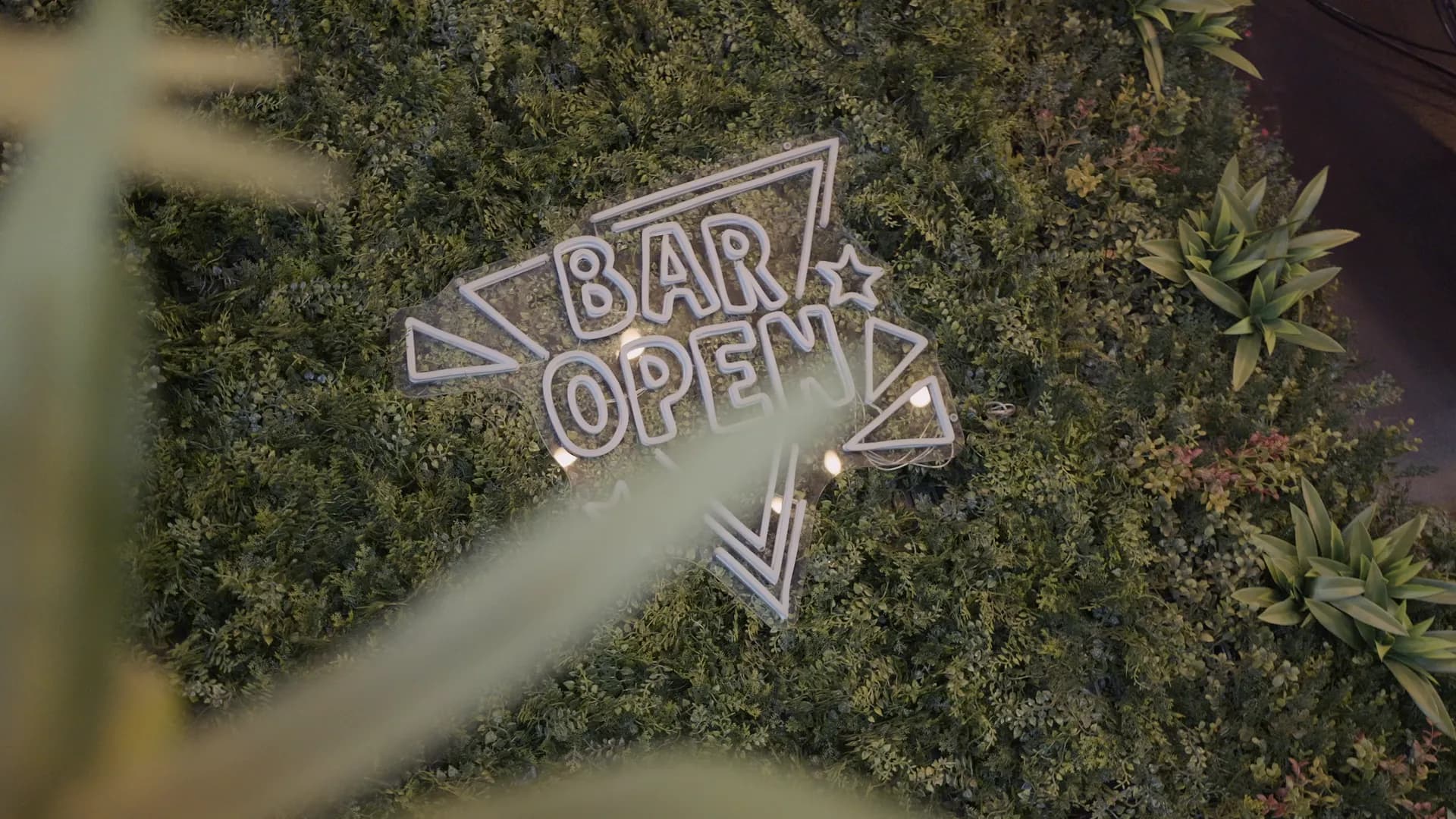 Neonskylten Bar Open på den gröna väggen
